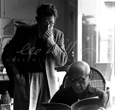 Roland Penrose and Picasso reading the first edition of Penrose's book 'Portraits of Picasso'. Cannes, France, 1957.